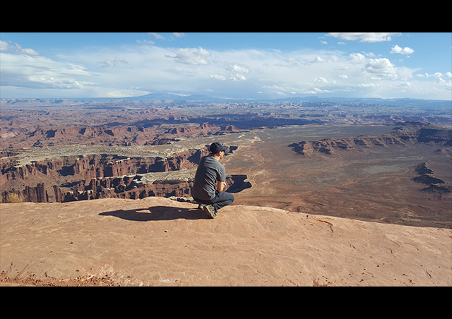 Peering over the edge at Grand View Point in Utah's Canyonlands National Park